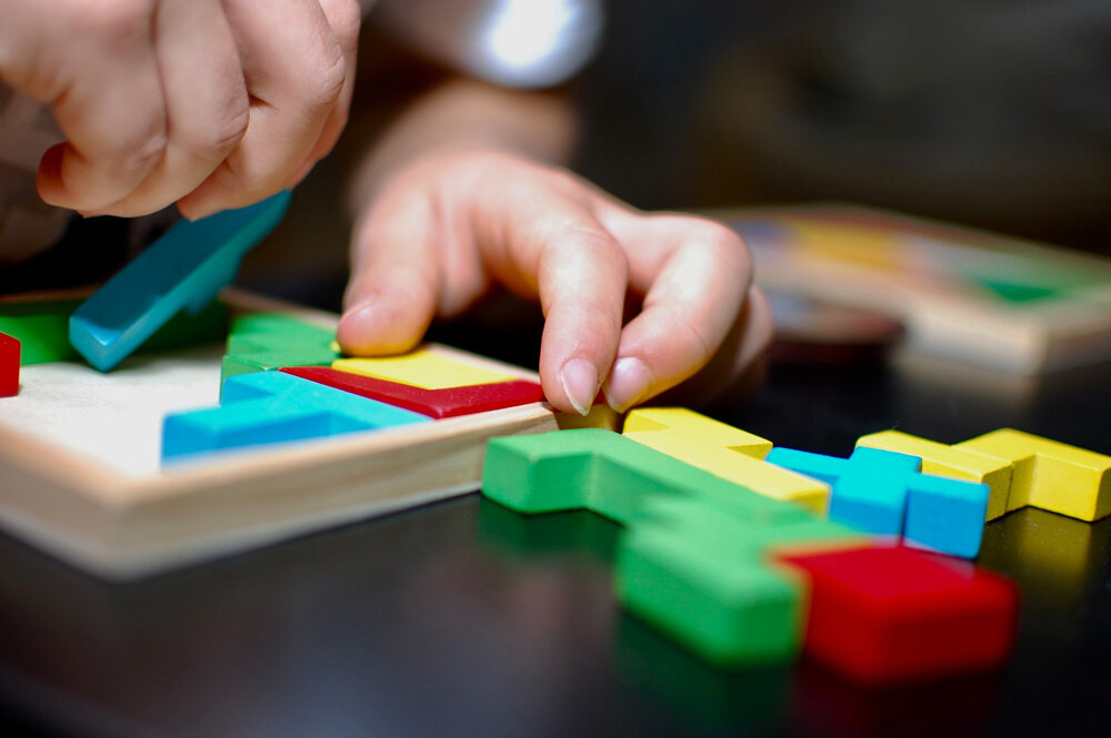An individual works on a puzzle.